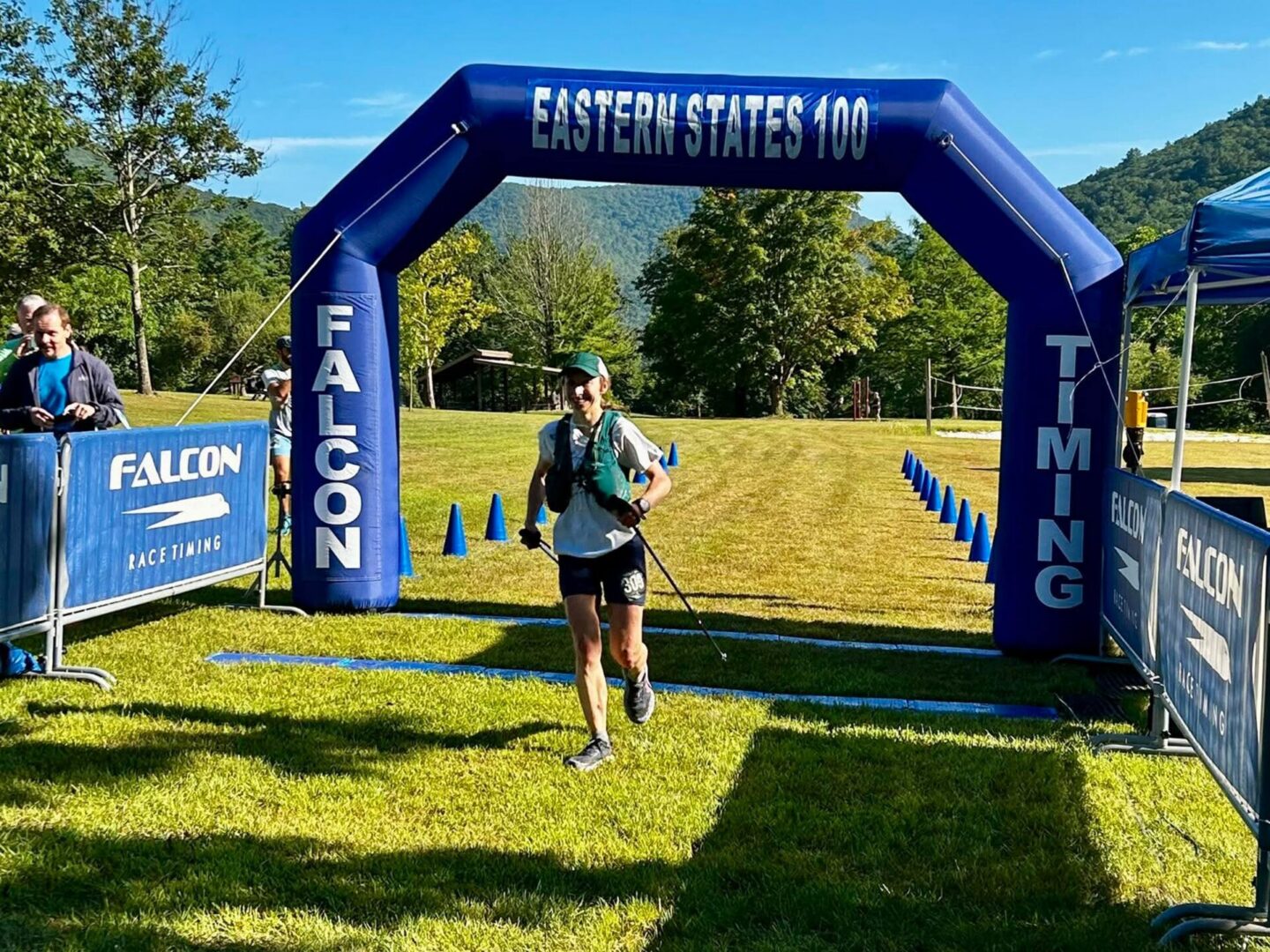 Person finishes under blue race archway