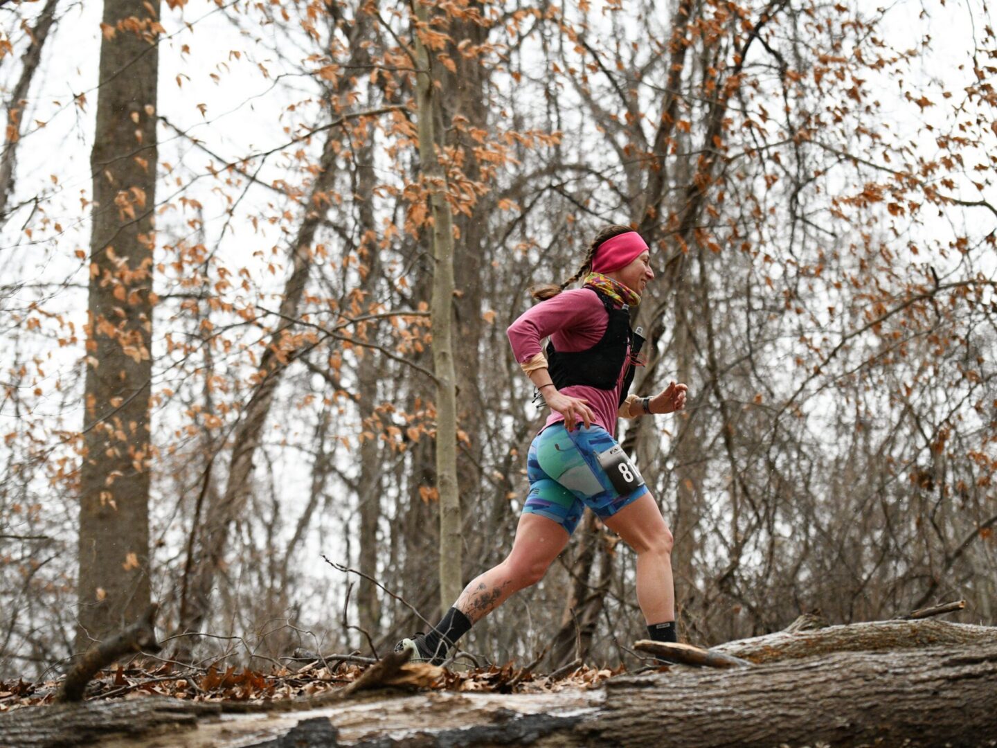 Trail runner in autumn forest